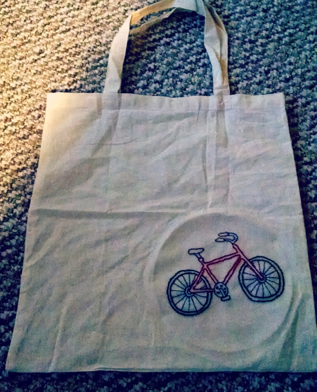 Backstitched embroidered bike on a tote bag